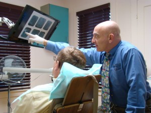 Dr. Ross explains x-ray to patient 